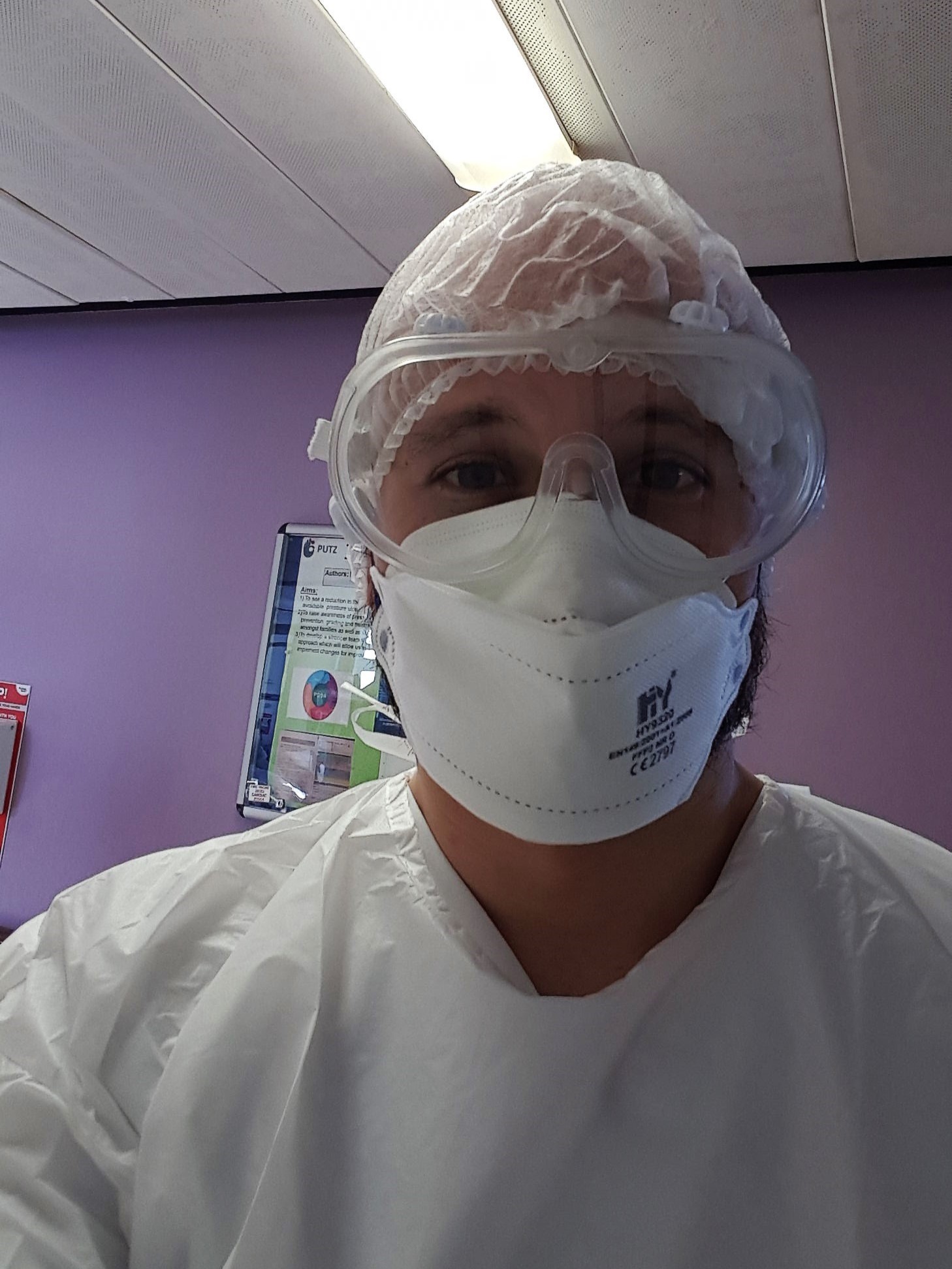 A selfie of Manuel at work wearing PPE (goggles, 
                    cap, face-mask and apron). Taken back when Covid-19 started.